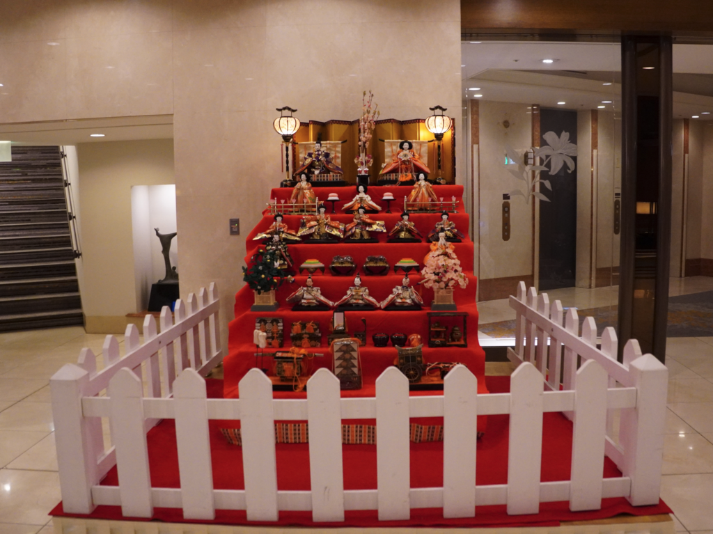 a red staircase with a white fence and a white fence