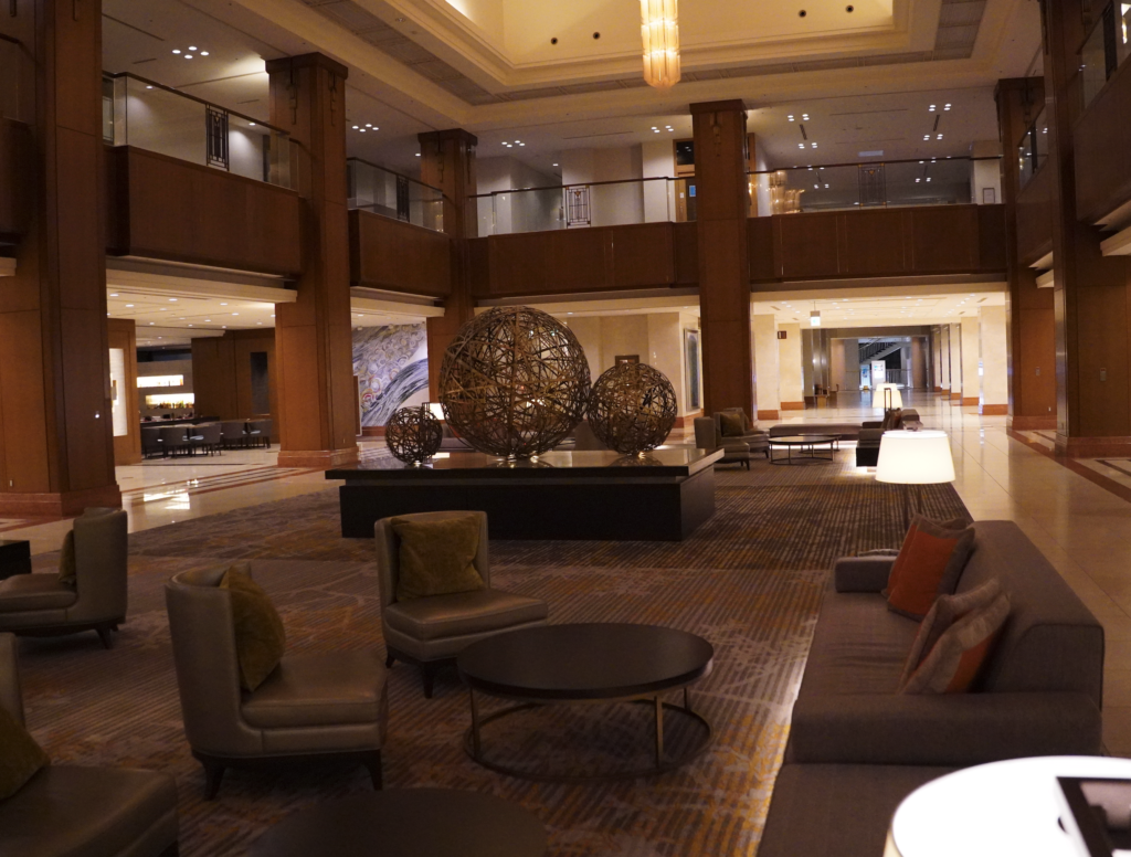 a large lobby with a large round table and chairs