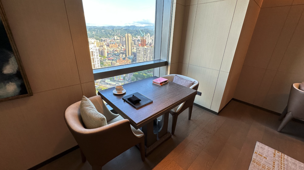 a table with two chairs and a cup on it