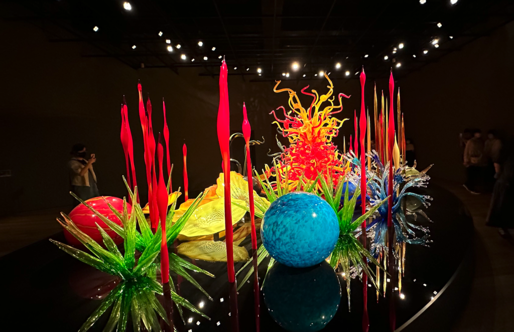 a group of glass sculptures on a black surface