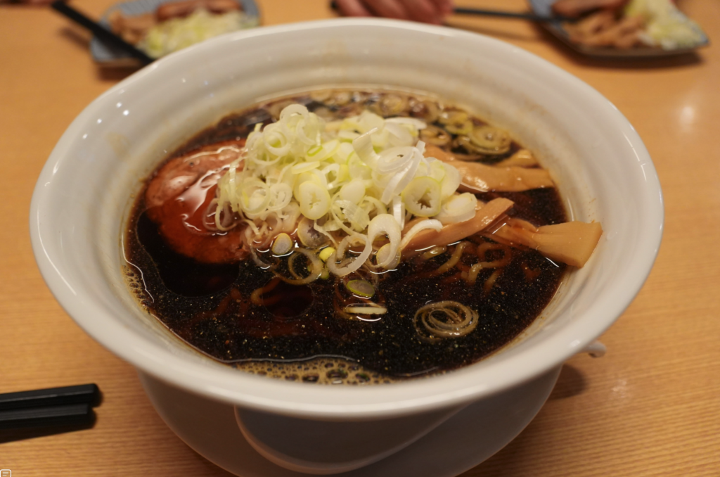 a bowl of soup with onions and meat